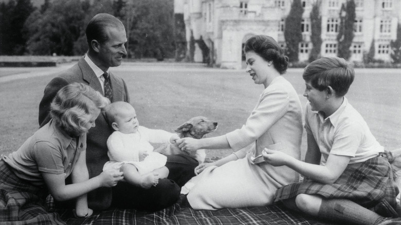 Queen Elizabeth and Prince Philip with their children on a picnic blanket at Balmoral