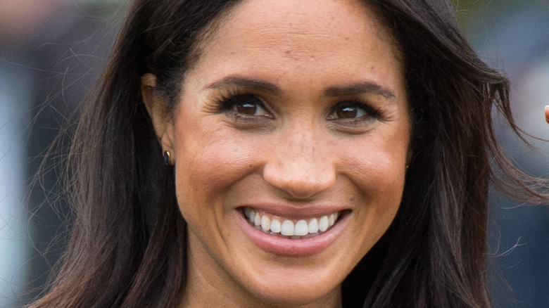 Meghan Markle smiles at an event