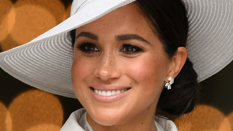 Meghan Markle smiling in all-white at the Platinum Jubilee