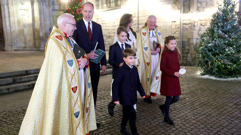 Catherine, Princess of Wales, Prince Louis of Wales, Princess Charlotte of Wales, Prince William, Prince of Wales and Prince George of Wales process out of The "Together At Christmas" Carol Service