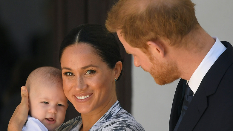 Archie, Meghan, and Harry posing