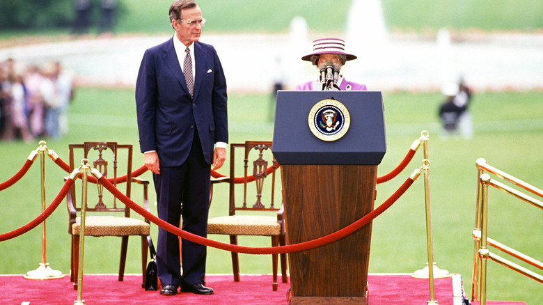 Queen Elizabeth II disappears behind the podium on her state visit of the U.S.