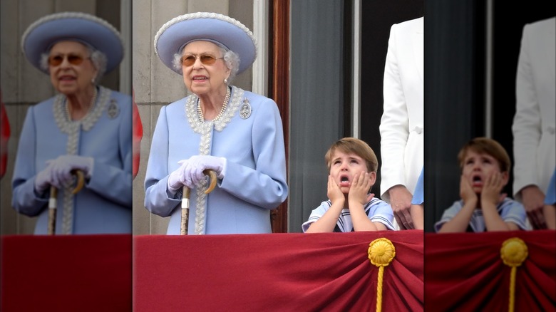 Queen Elizabeth II and Prince Louis both looking equally perplexed as they stand next to each other on the Buckingham Palace balcony