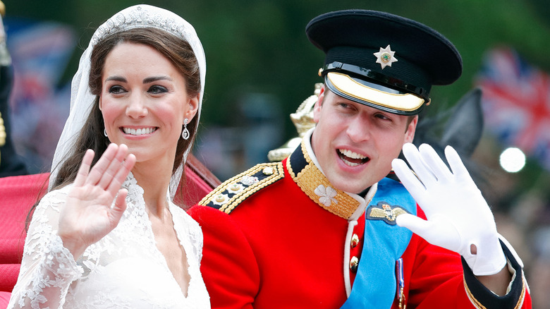 Kate Middleton and Prince William smiling and waving on their wedding day