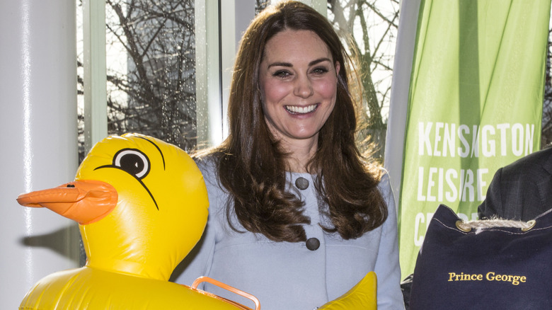 Kate Middleton holding an inflatable duck pool toy