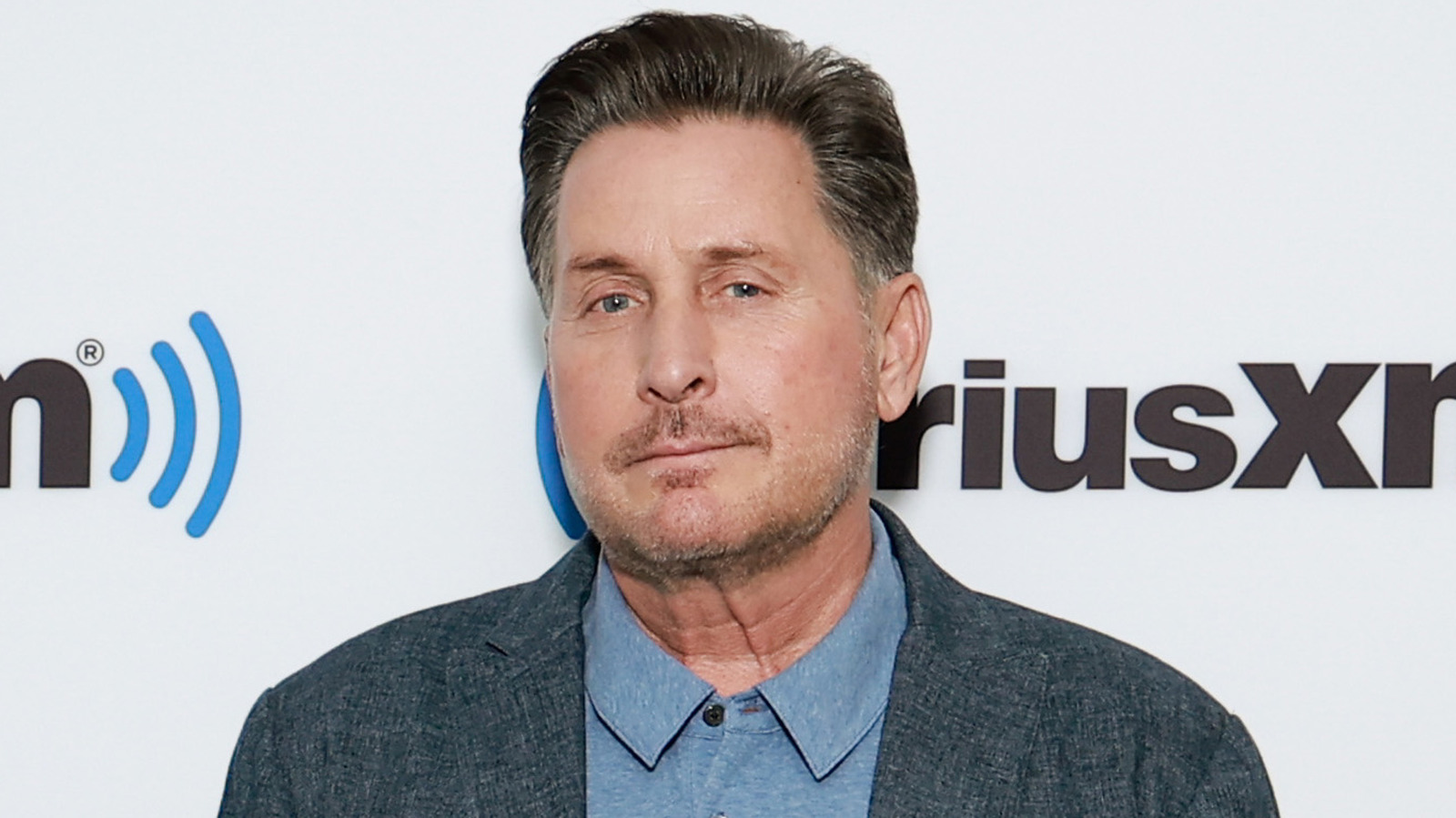 The Sad Reason Charlie Sheen's Brother Emilio Estevez Didn't Change His
