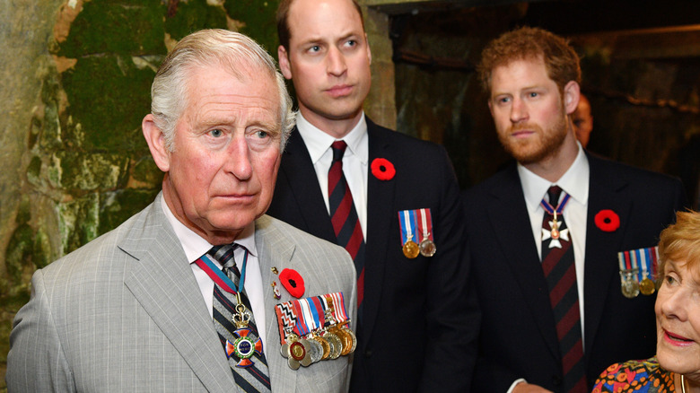 King Charles pictured with Prince William and Prince Harry all looking sullen in suits