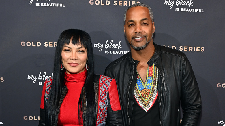 Egypt Sherrod and Mike Jackson standing in front of black backdrop