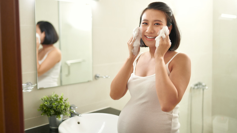 pregnant woman washing face
