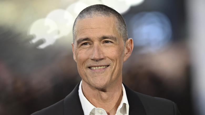 Matthew Fox with graying hair and a smile at an event.