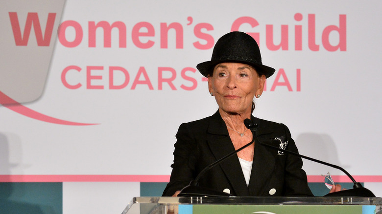 Judge Judy speaking on stage at a 'Women's Guild' event