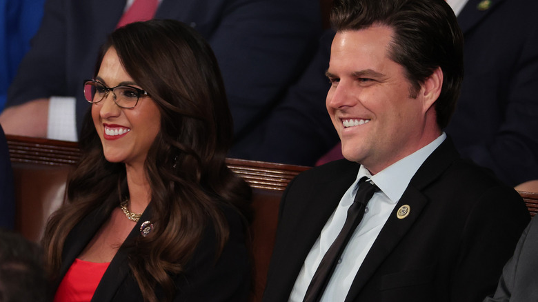 A smiling Lauren Boebert and Matt Gaetz sitting next to each other