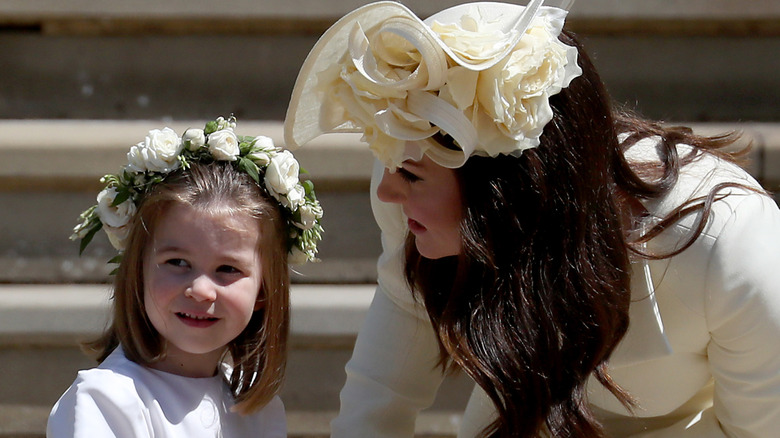 Princess Charlotte of Cambridge stands on the steps with her mother Catherine, Duchess of Cambridge after the wedding of Prince Harry and Ms. Meghan Markle at St George's Chapel at Windsor Castle (2018)