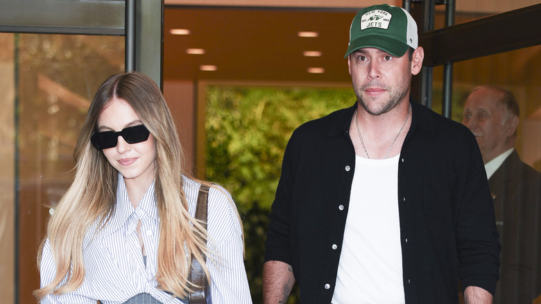 Sydney Sweeney and Scooter Braun exiting a building together.