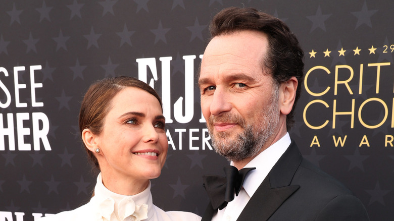 Keri Russell looking lovingly up at Matthew Rhys while posing on the red carpet in their finery