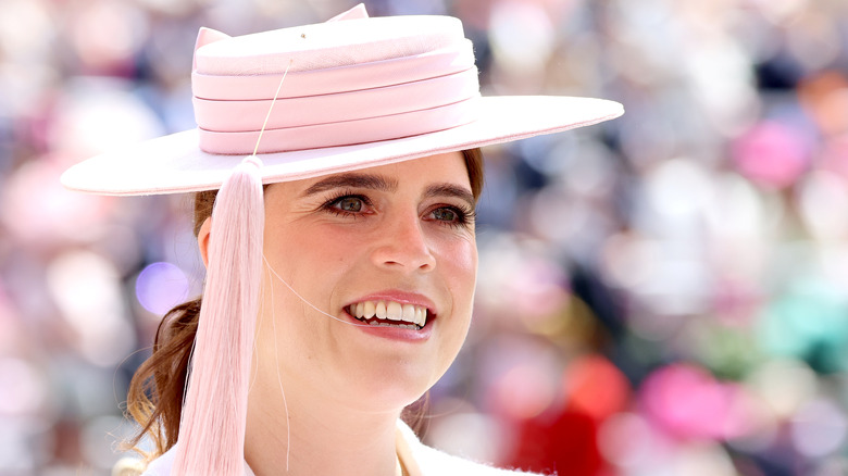 Princess Eugenie wears a hat and smiles