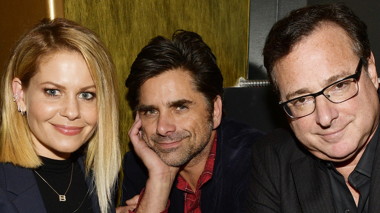 Candace Cameron Bure, John Stamos, and Bob Saget at an event. 