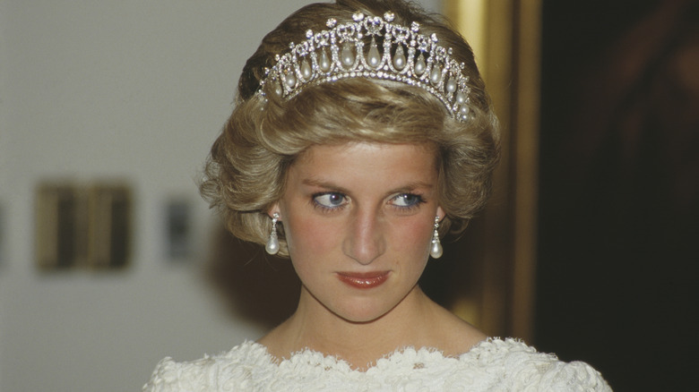 Princess Diana wearing a white gown and pearl drop tiara for a dinner in Washington in 1985.