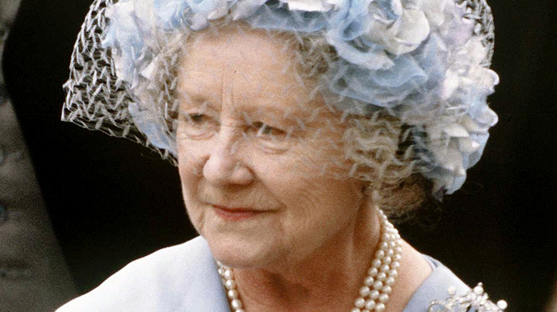 Close-up photo of the Queen Mother looking off to the side while wearing pastel blue.