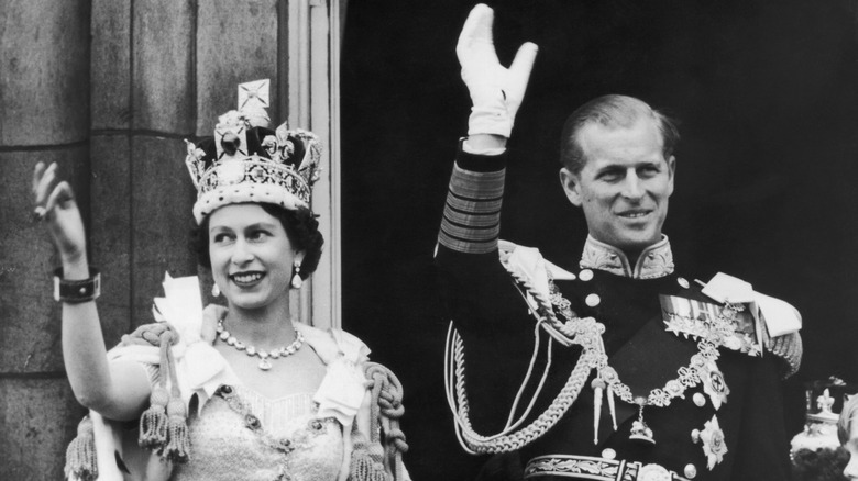 Queen Elizabeth II and Prince Philip wave at her coronation