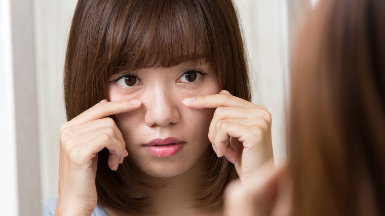 Woman looking in mirror