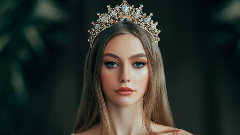 Glamorous woman wearing beautiful makeup and crown