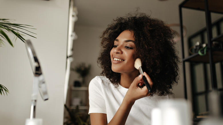 Woman applying face powder