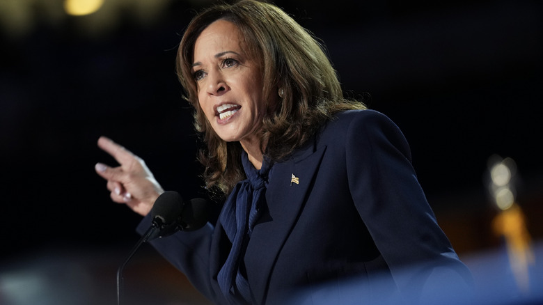 Kamala Harris delivering a passionate speech in a navy suit