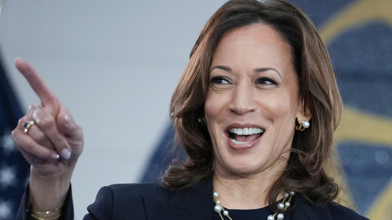 Kamala Harris laughing while pointing a finger at someone