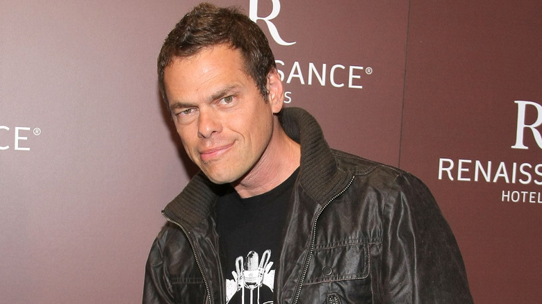 Vince Offer posing for photos in a dark outfit
