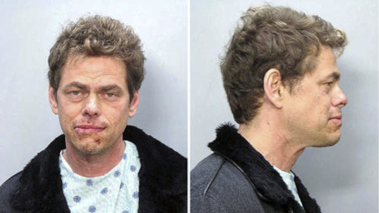 Vince Offer posing for his mugshots