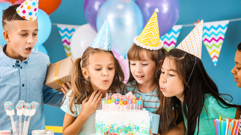 Kids in party hats at birthday party