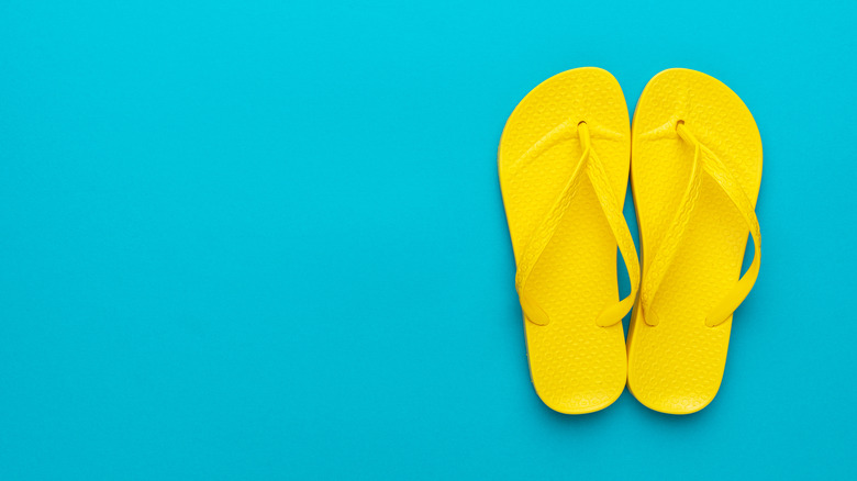 Yellow flip flops on a blue background