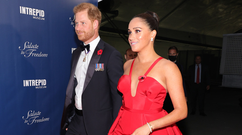 Meghan Markle wearing a red evening gown 
