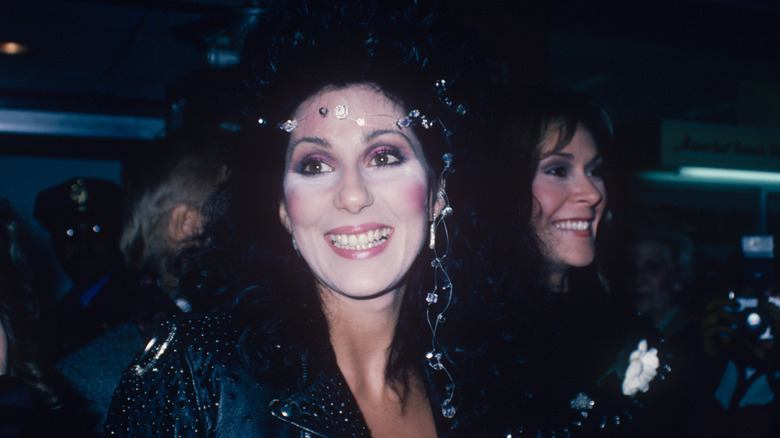 Cher smiles while sporting a studded leather coat and jeweled headpiece in New York (1970)