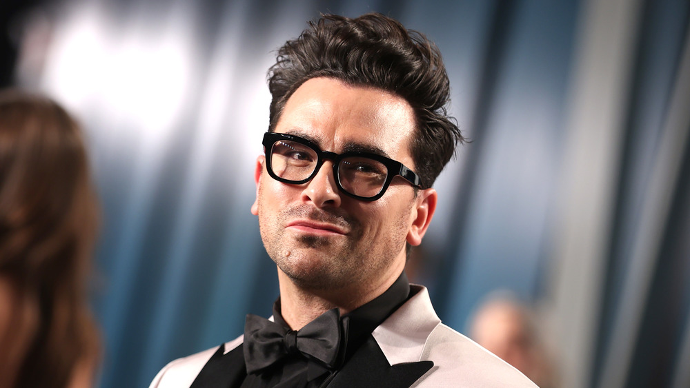 Dan Levy posing with a small smile