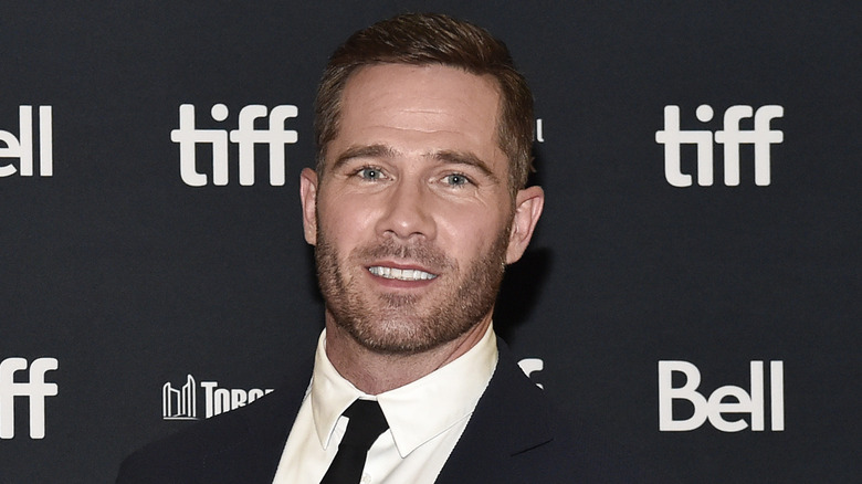 Luke Macfarlane poses on the red carpet