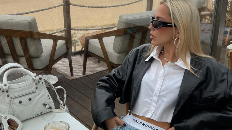 blonde woman in balenciaga drinking coffee