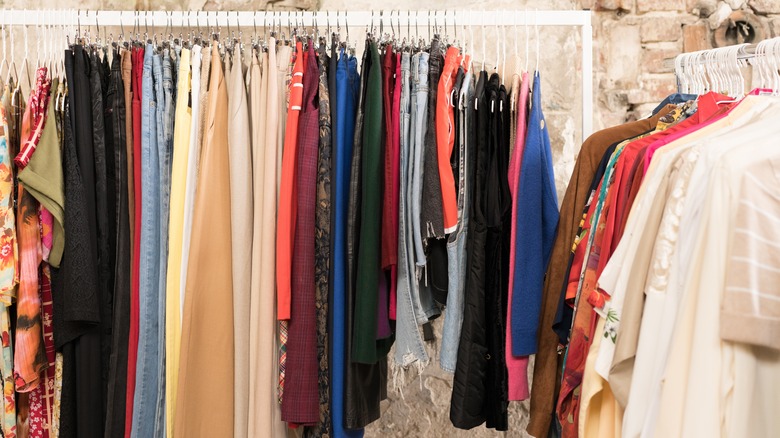 clothes on rack at thrift store