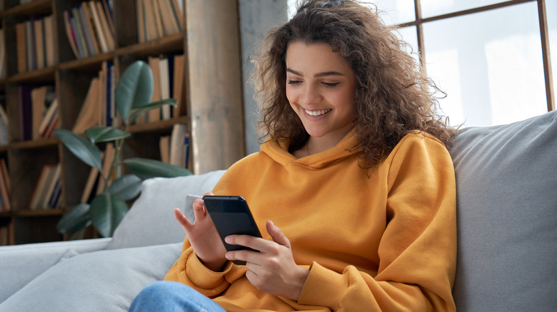 woman smiling looking at phone 