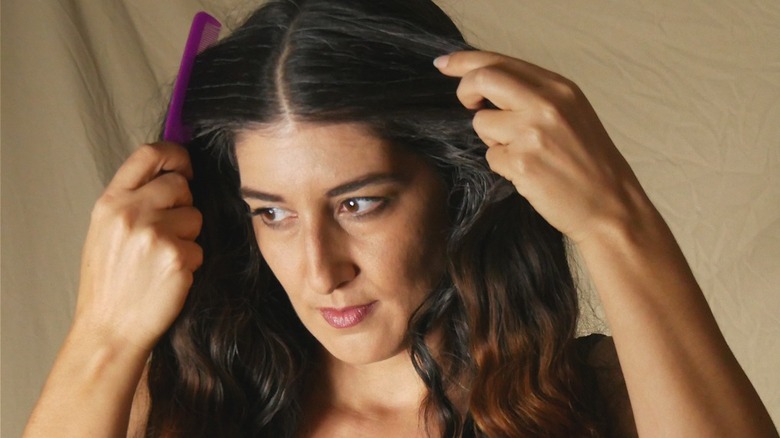 woman parting her hair down middle