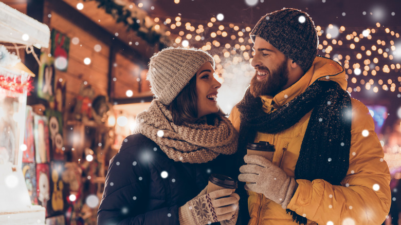 Couple drinks coffee in the snow