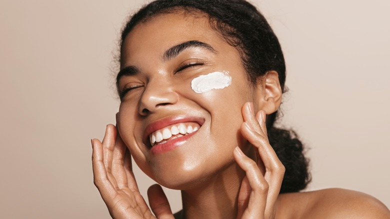 Person smiling with lotion on face