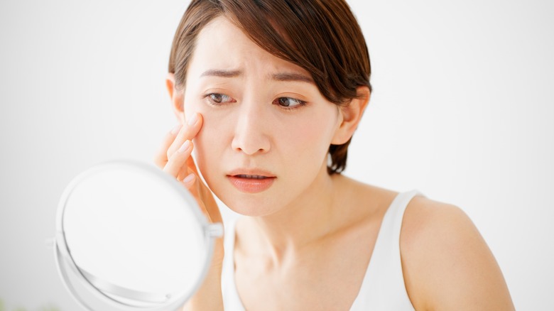 Woman looking in mirror