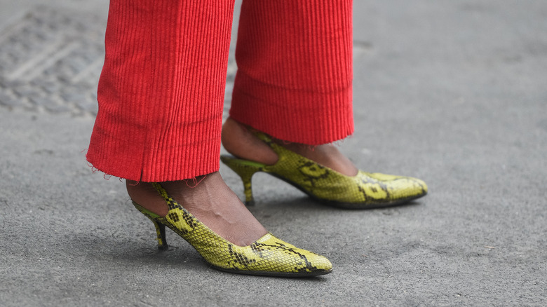 Woman wearing snakeskin kitten heels