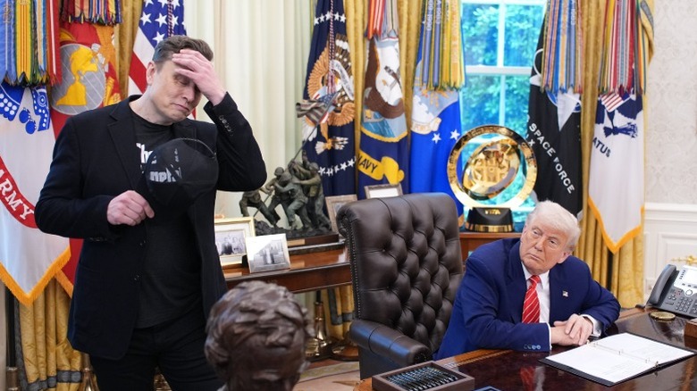 Elon Musk grimaces while he and Donald Trump listen to a question from reporters in the Oval Office (2025)
