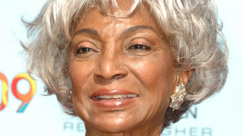 NIchelle NIchols smiling at a press event