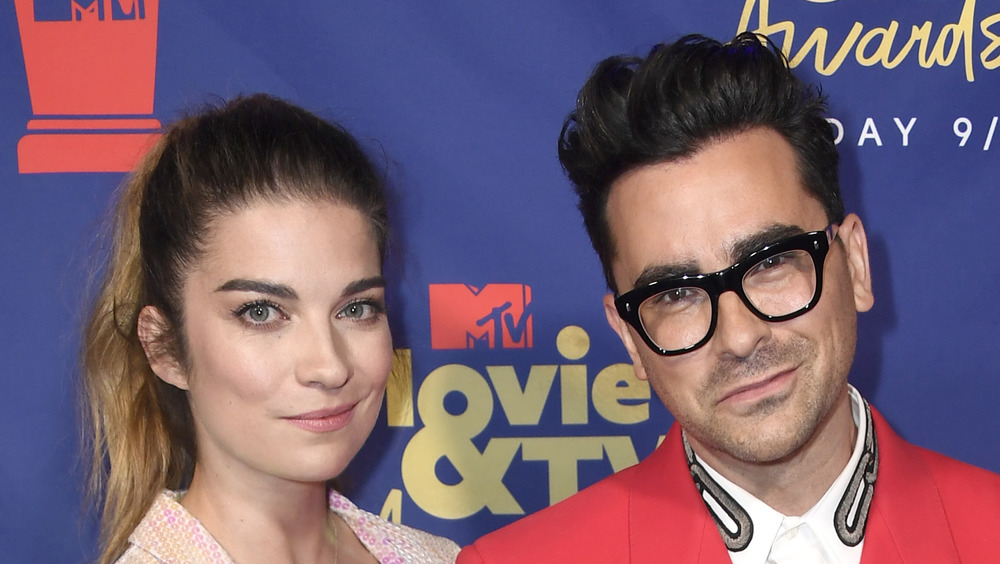 Annie Murphy and Dan Levy cuddle up at an event