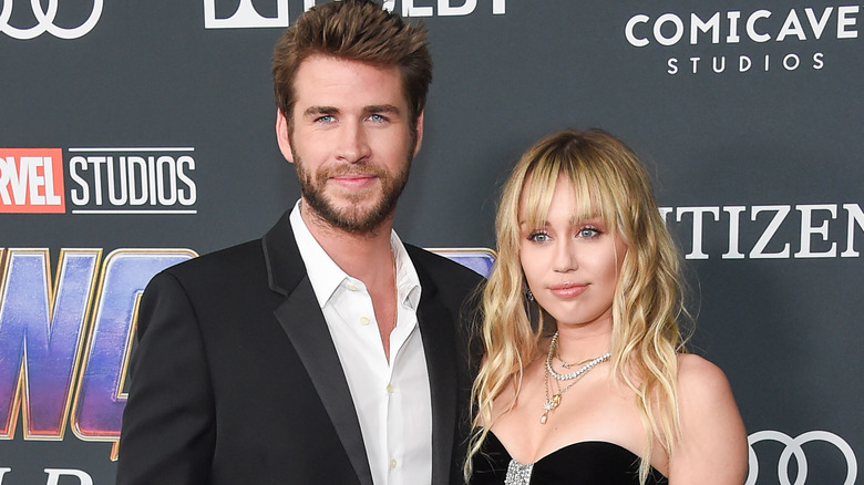 Liam Hemsworth and Miley Cyrus posing