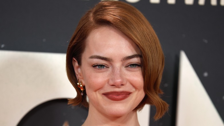 Emma Stone smiling on the red carpet of an event